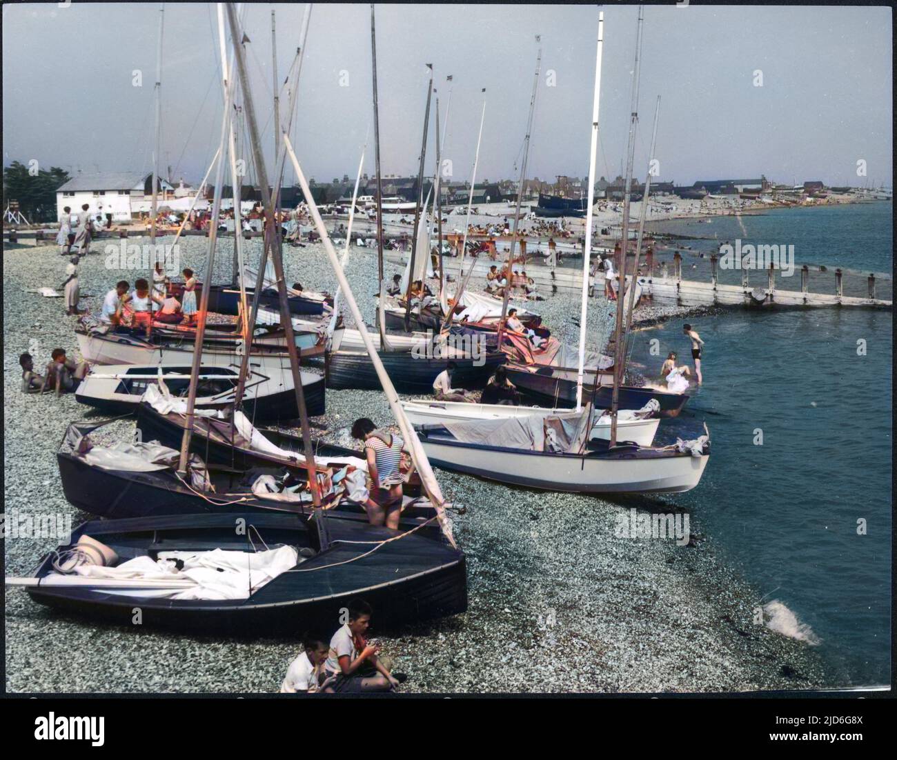 A busy scene on the Crumbles, a long stretch of shingles, from Eastbourn to Pevensey Bay, formed by the tidal wash of the sea. Colourised version of : 10172184       Date: late 1950s Stock Photo