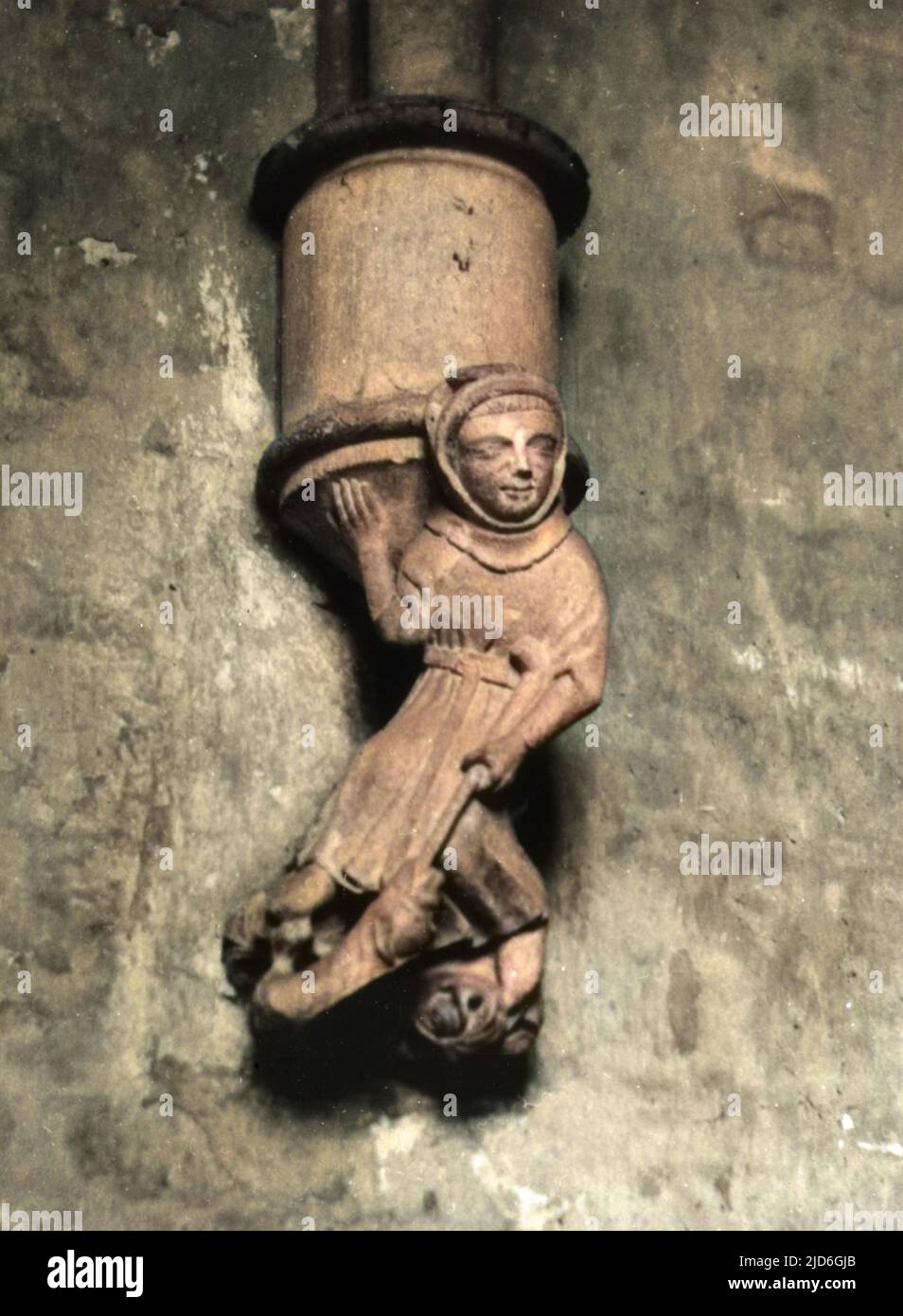 A medieval corbal of a peasant thrusting his staff into a dragon's mouth, in the Chapter House of Well's Cathedral, Somerset, England. Colourised version of : 10181462       Date: 14th century Stock Photo