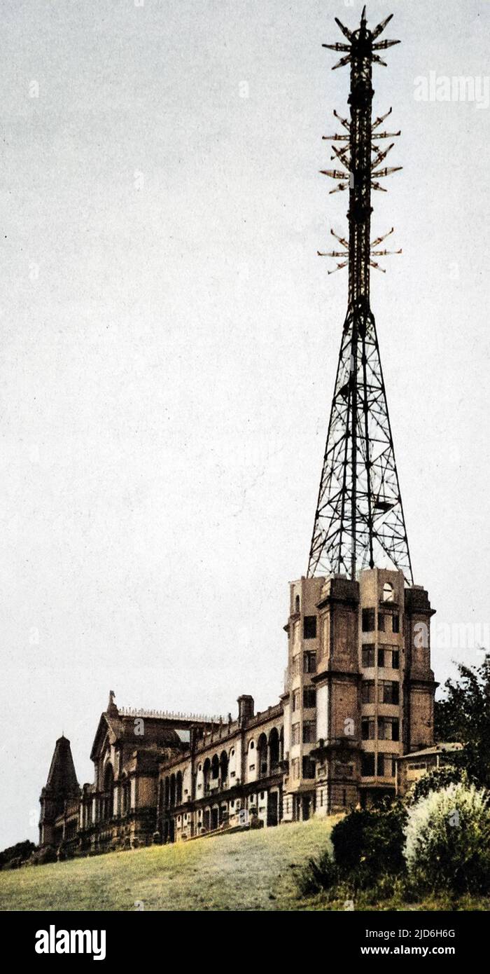 Alexandra Palace as the home of the B.B.C television service, showing the mast and transmitting aerials for vision and sound. Special tests of reception of the B.B.C from Alexandra Palace of synchronised television and speech were held at Olympia by a committee of the Radio Manufacturers' Association. On alternate days transmissions from Alexandra Palace were given by Baird and Marconi E.M.I systems. In 1935 the B.B.C experimented with John Logie Baird's television system and Marconi's E.M.I system. The E.M.I succeeded Baird's in 1937. Colourised version of: 10216489       Date: 1936 Stock Photo