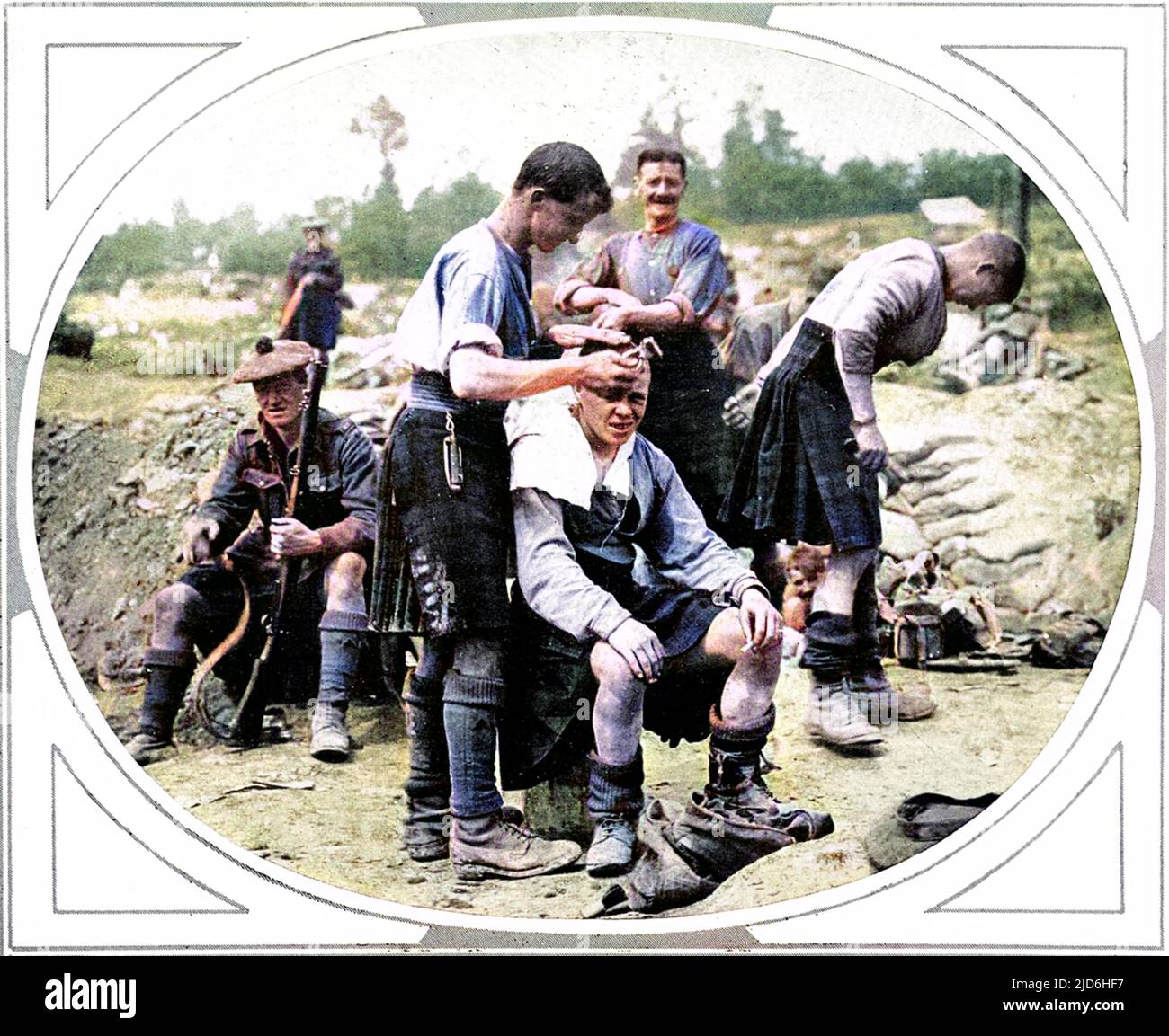 A Scottish army barber is shown cutting another soldier's hair. Colourised version of: 10219644       Date: Aug-16 Stock Photo