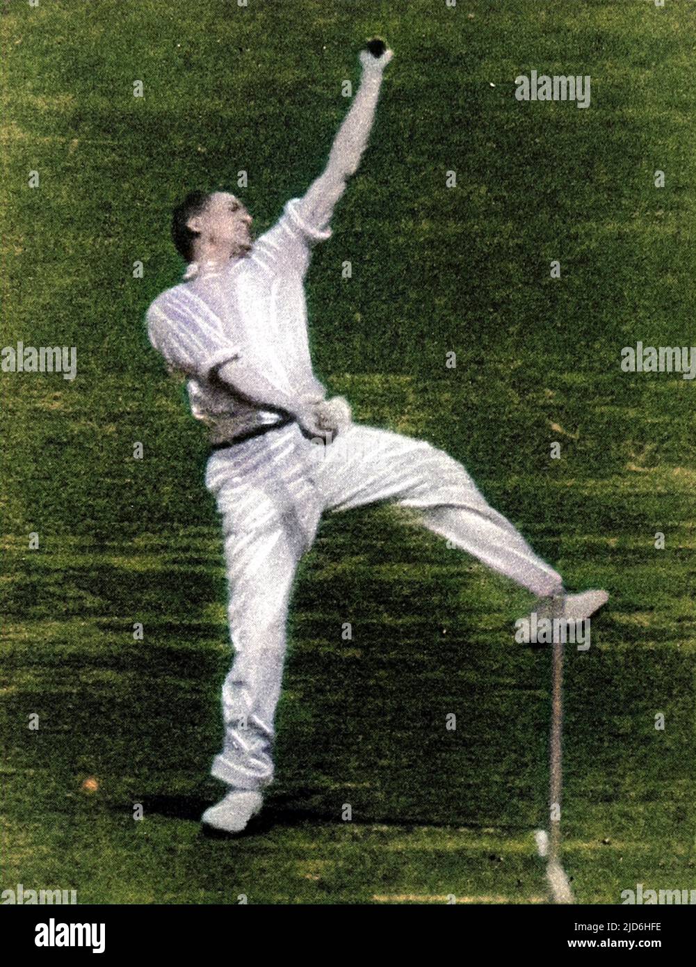 Photograph of the English bowler, Harold Larwood, in action during the MCC tour of Australia, 1933.   During that tour, D.R. Jardine, the MCC Captain, used the pace of Larwood to employ 'leg theory' (also known as 'bodyline' bowling).   Although successful on the cricket field, the tactic was deemed unsportsmanlike by many Australians and soured Anglo-Australian relations. Colourised version of: 10218973       Date: 1933 Stock Photo