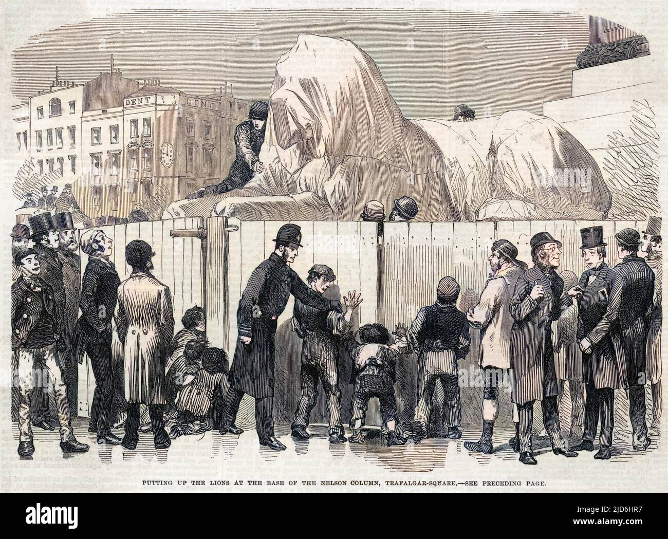Construction of the lion statues at the base of Nelson's Column, Trafalgar Square, London, 1867.   In the background, one of the lions is kept 'under wraps', whilst in the foreground a policemen keeps an eye on a number of children looking through the fence. Colourised version of: 10220901       Date: 1867 Stock Photo