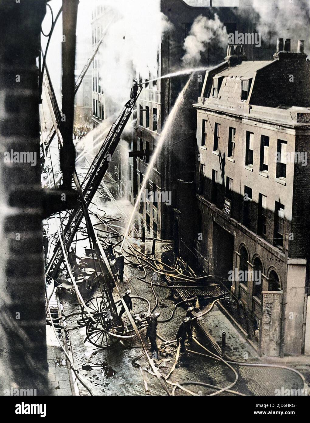 Members of the London Fire Brigade tackling a blaze at Samuel Ward & Co.'s paint and varnish warehouse in Great Guildford Street, Southwark, August 1926. Colourised version of: 10220885       Date: 1926 Stock Photo