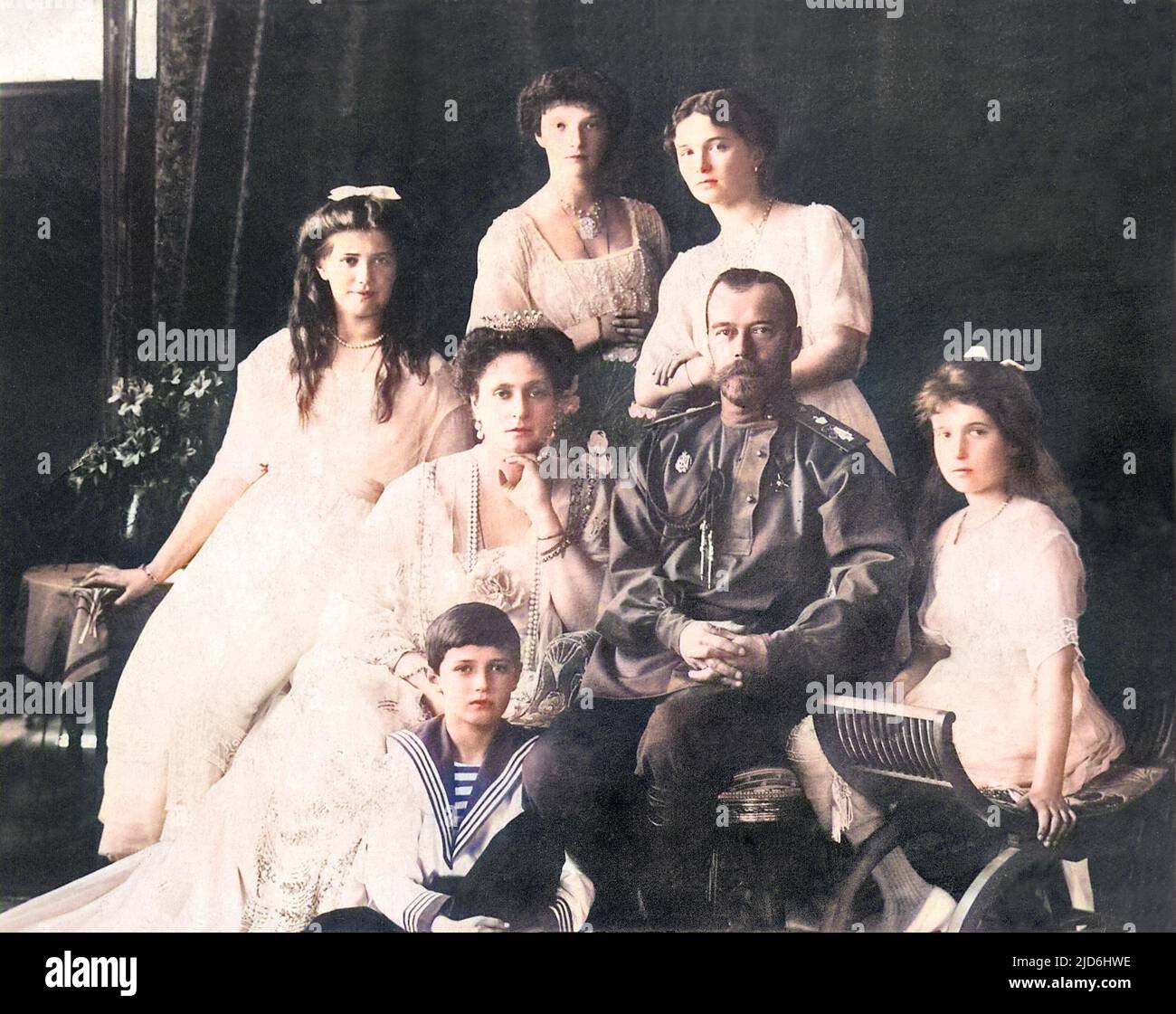 Tsar Nicholas II with his wife Tsaritsa Alexandra Feodorovna and their five children, from left; Maria, Alexei (seated on floor), Olga, Tatiana and Anastasia. Colourised version of: 10223934 Stock Photo
