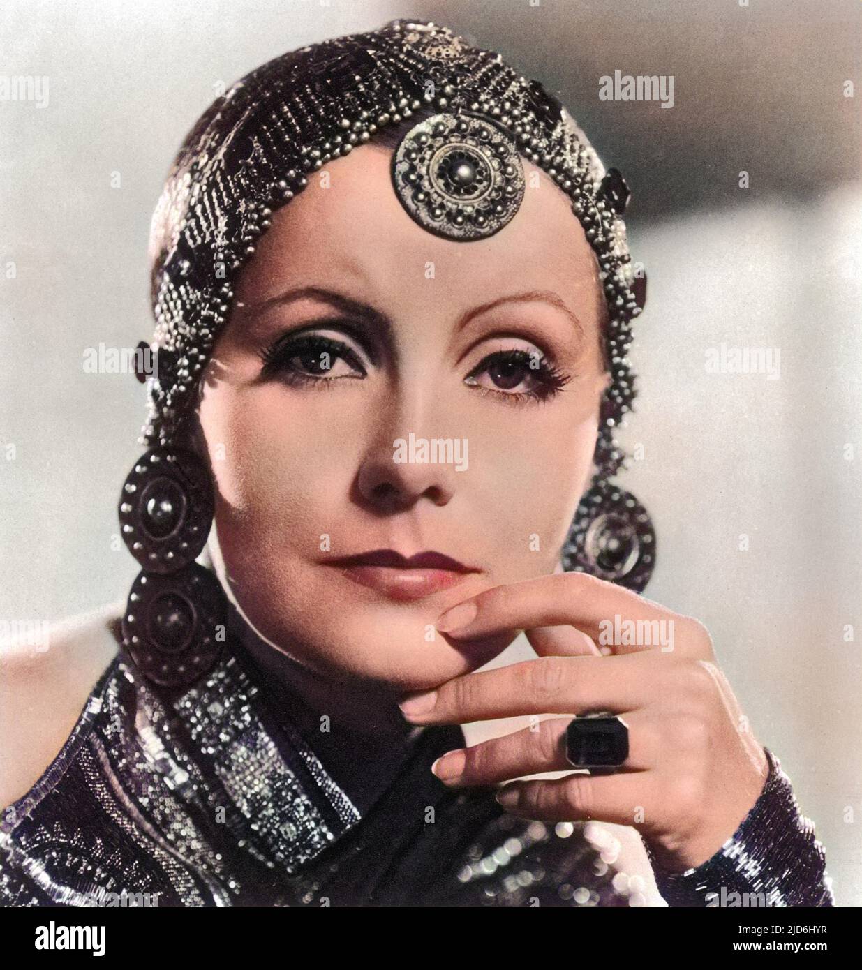 Greta Garbo  (1905 - 1990), as Mata Hari. Greta Garbo was born in Stockholm and was 'spotted' whilst studying at the Royal Theatre Dramatic School by the Swedish director Mauritz Stiller. Her first Hollywood film was 'The Temptress' 1926. Amongst her other successes are, 'Queen Christie' (1930), 'Anna Karenina' (1935) and 'Ninotchka' (1939). She retired from films in 1941, after receiving poor reviews for 'Two-Faced Woman.' She spent the rest of her life living as a recluse in New York. Colourised version of: 10222758       Date: 1932 Stock Photo