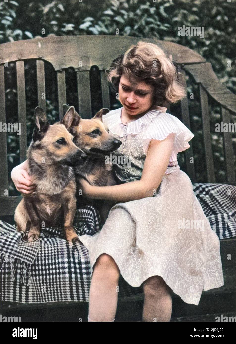 Princess Elizabeth of York (now Queen Elizabeth II) taken at the York's London residence, 145, Piccadilly in 1936 with two of her corgis. Colourised version of: 10222822       Date: 1936 Stock Photo