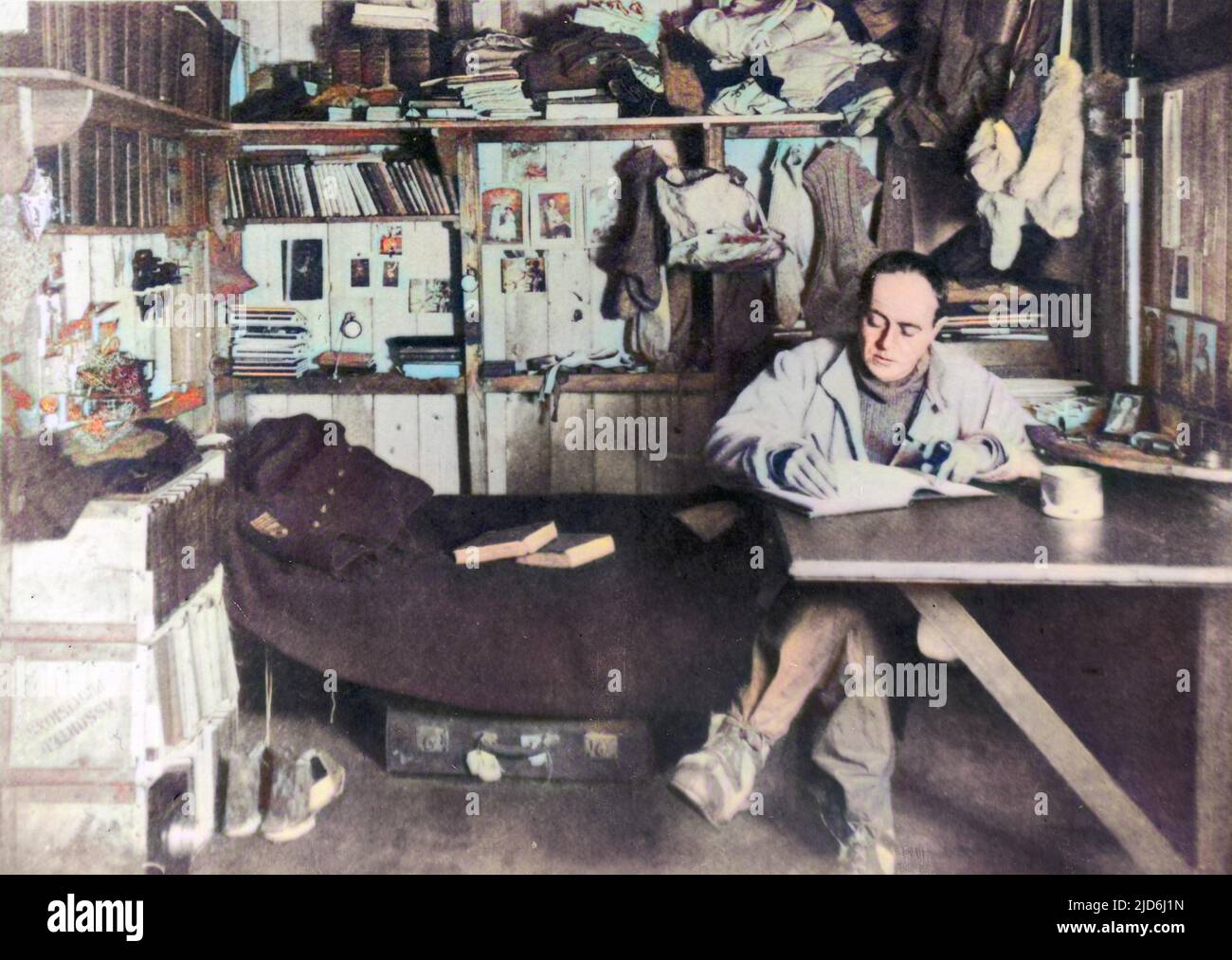 Captain Robert Falcon Scott (1868 - 1912), British polar explorer and leader of the ill-fated expedition to the South Pole in 1912, pictured in his work room on board the Terra Nova. Colourised version of: 10419298       Date: 1911 Stock Photo