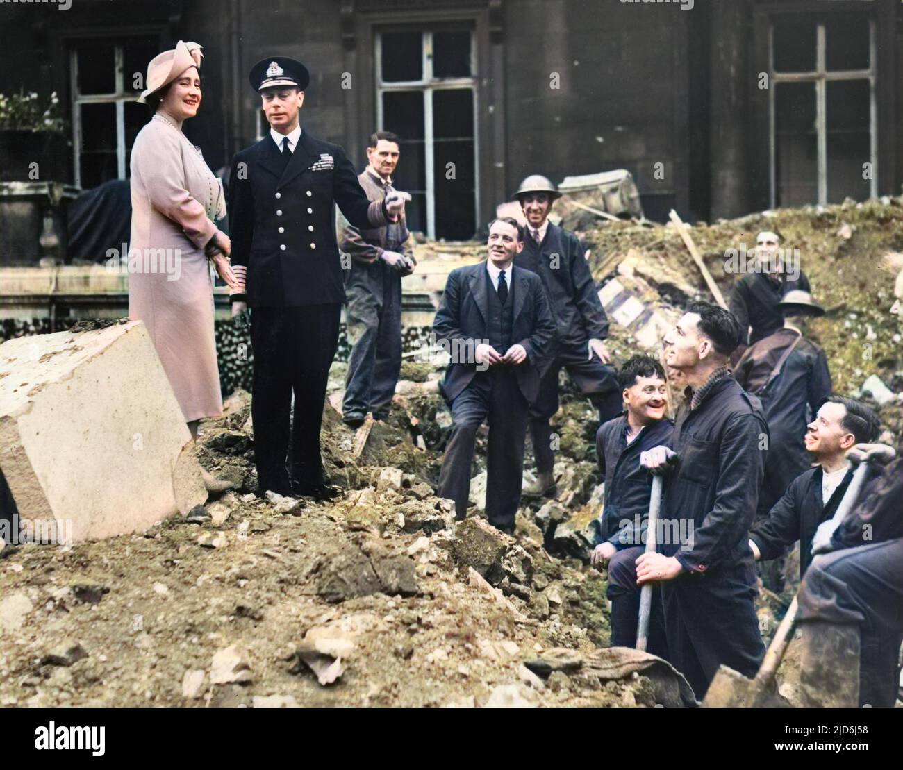 King George VI and Queen Elizabeth pictured among the rubble at Buckingham Palace following German air raids during the Blitz, September 1940.  The Palace suffered bomb damage on 8 September and on the morning of the 13th, the King and Queen were in residence when a bomb was dropped into the Quadrangle.  They escaped unhurt but one workman was killed. Colourised version of: 10435803       Date: 1940 Stock Photo