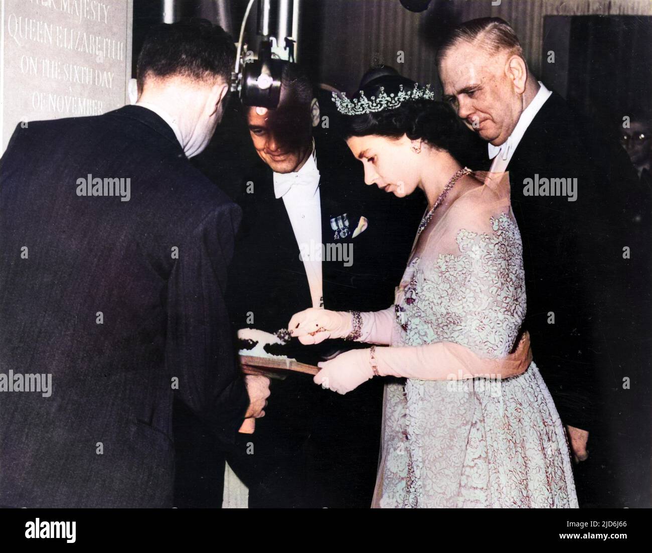 Queen Elizabeth II visits Lloyd's to lay the foundations tone of their new building in Lime Street. This picture shows her Majesty taking a trowel full of mortar ready to lay the stone. Colourised version of: 10510769       Date: 6th November 1952. Stock Photo