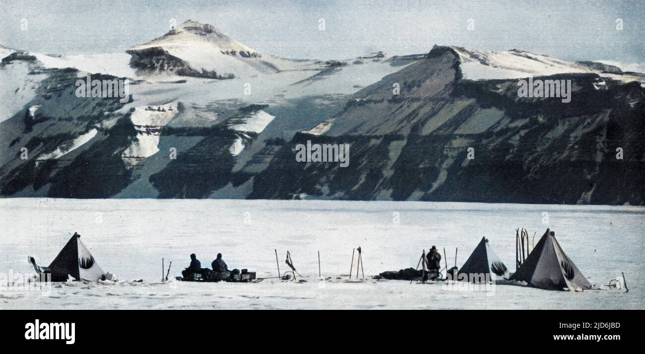 Photograph taken by Captain Scott during the ill-fated polar expedition to the South Pole in 1910 - 1912, showing tents pitched on the way up the Beardmore Glacier, with the Wild Range comprising the Adams, Marshall and Wild mountains with their horizontal stratification forming the backdrop. Colourised version of: 10528891       Date: 1913 Stock Photo