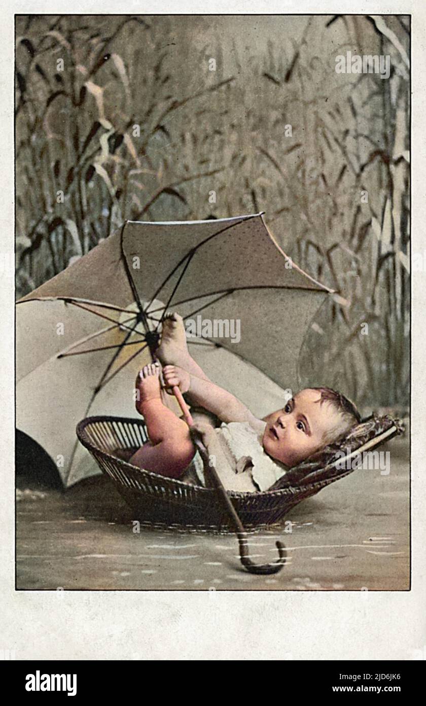 Small Baby boy in a Moses Basket amid the reeds. The child is showing admirable resourcefulness in taking along a brolly, in case of showers or passing high speed motor boats...    From Exodus 2 (verses 5-6): 'Then Pharaoh?s daughter went down to the Nile to bathe, and her attendants were walking along the riverbank. She saw the basket among the reeds and sent her female slave to get it. She opened it and saw the baby. He was crying, and she felt sorry for him. ?This is one of the Hebrew babies,? she said.' Colourised version of: 10644784       Date: 1904 Stock Photo