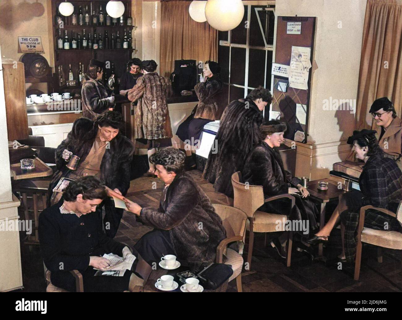 The Women's Press Club of London - founded in 1948. Members in the bar lounge of the club premises in Carey Street, close to Fleet Street, London. Women press visitors from abroad may become honourary members for the duartion of their visit. Colourised version of: 10720114       Date: 1949 Stock Photo