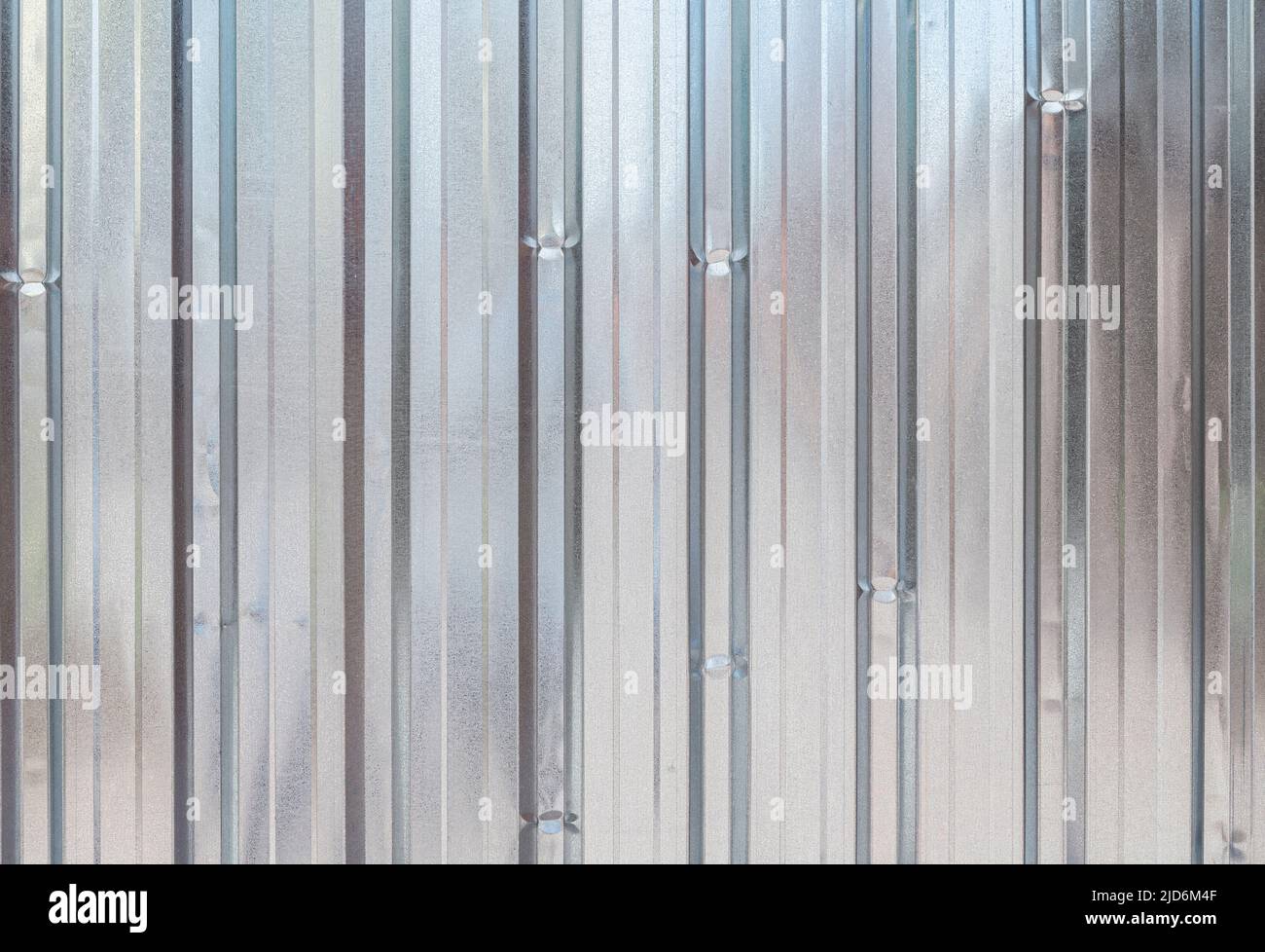 Shiny, corrugated, galvanized metal wall background, front view. High resolution full frame textured abstract background. Copy space. Stock Photo