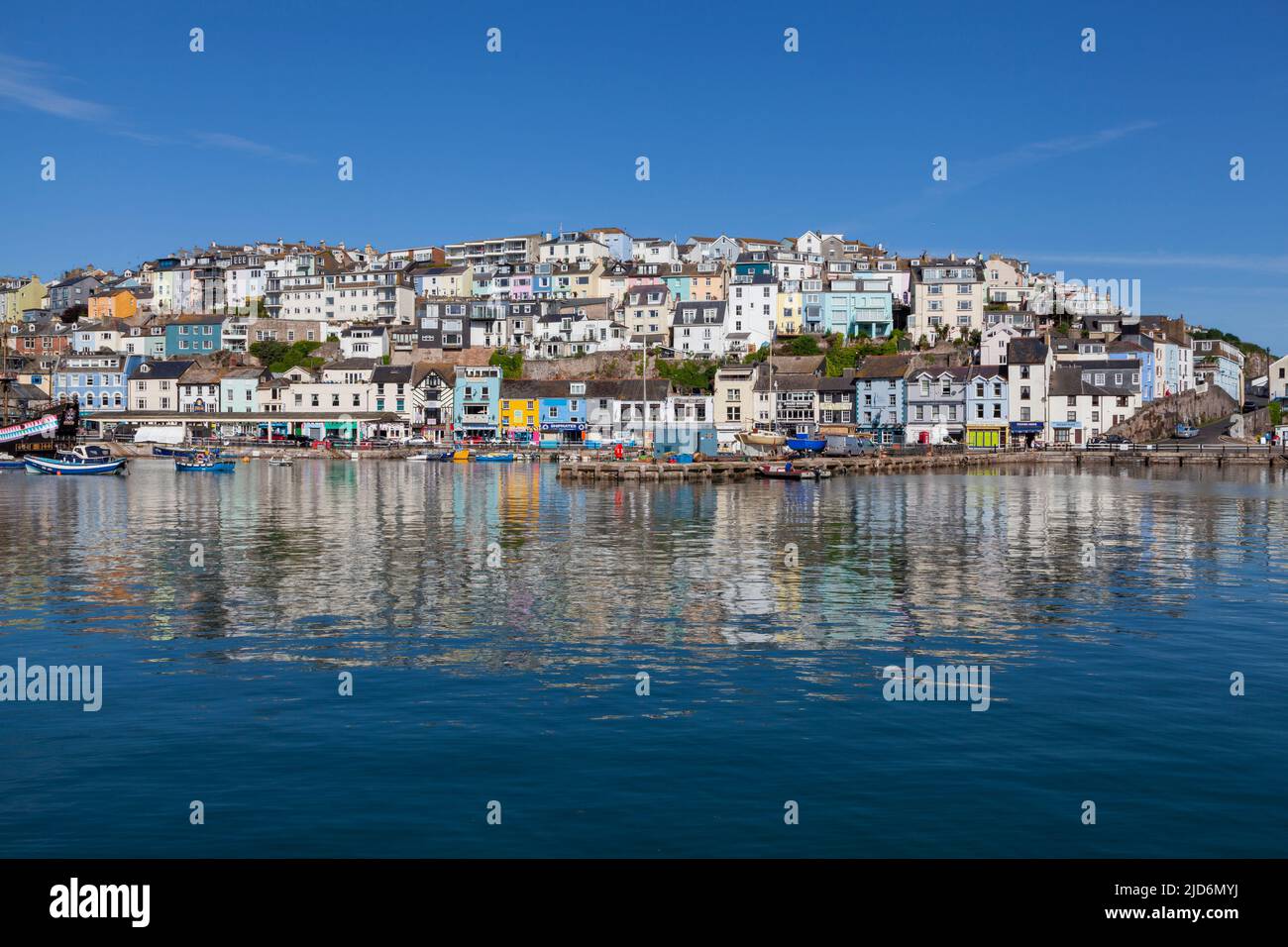 Brixham Harbour & Marina, Devon, England, UK –tethered and anchored boats casting highly patterned reflections on mirror-like sea Stock Photo