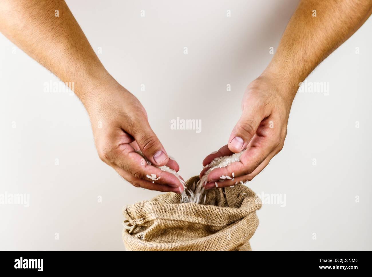 Hands holding rice, bag of rice Stock Photo Alamy