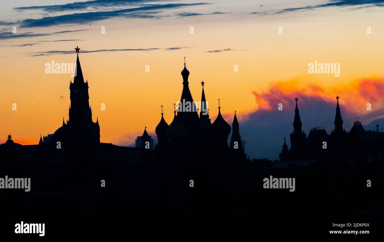 Black silhouette of Cathedral of Vasily the Blessed, Spasskaya Tower and Kremlin. Sunset sky. High quality photo Stock Photo