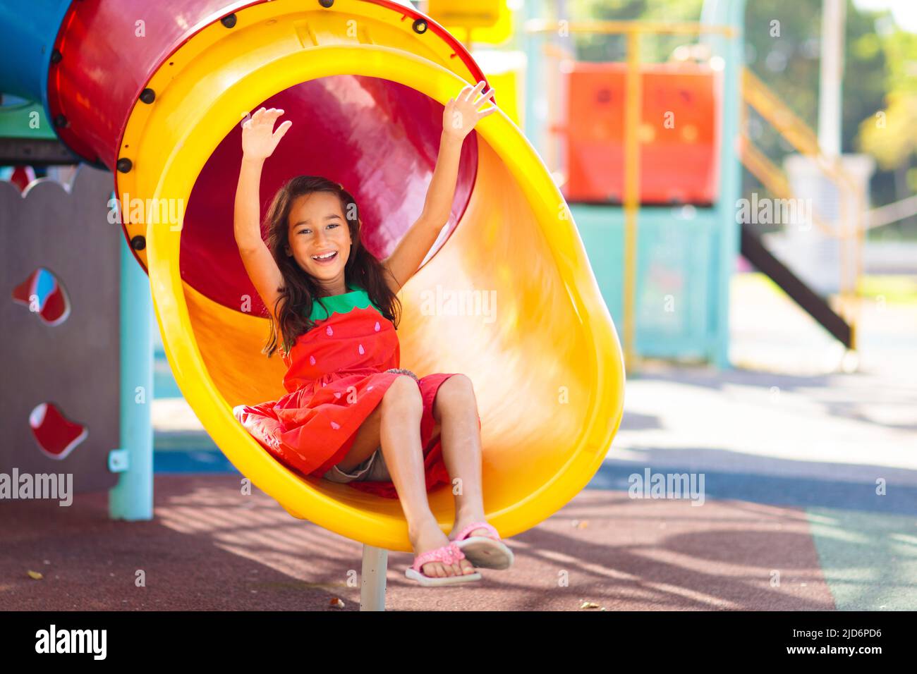 Kids on playground. Children play outdoor on school yard slide. Healthy