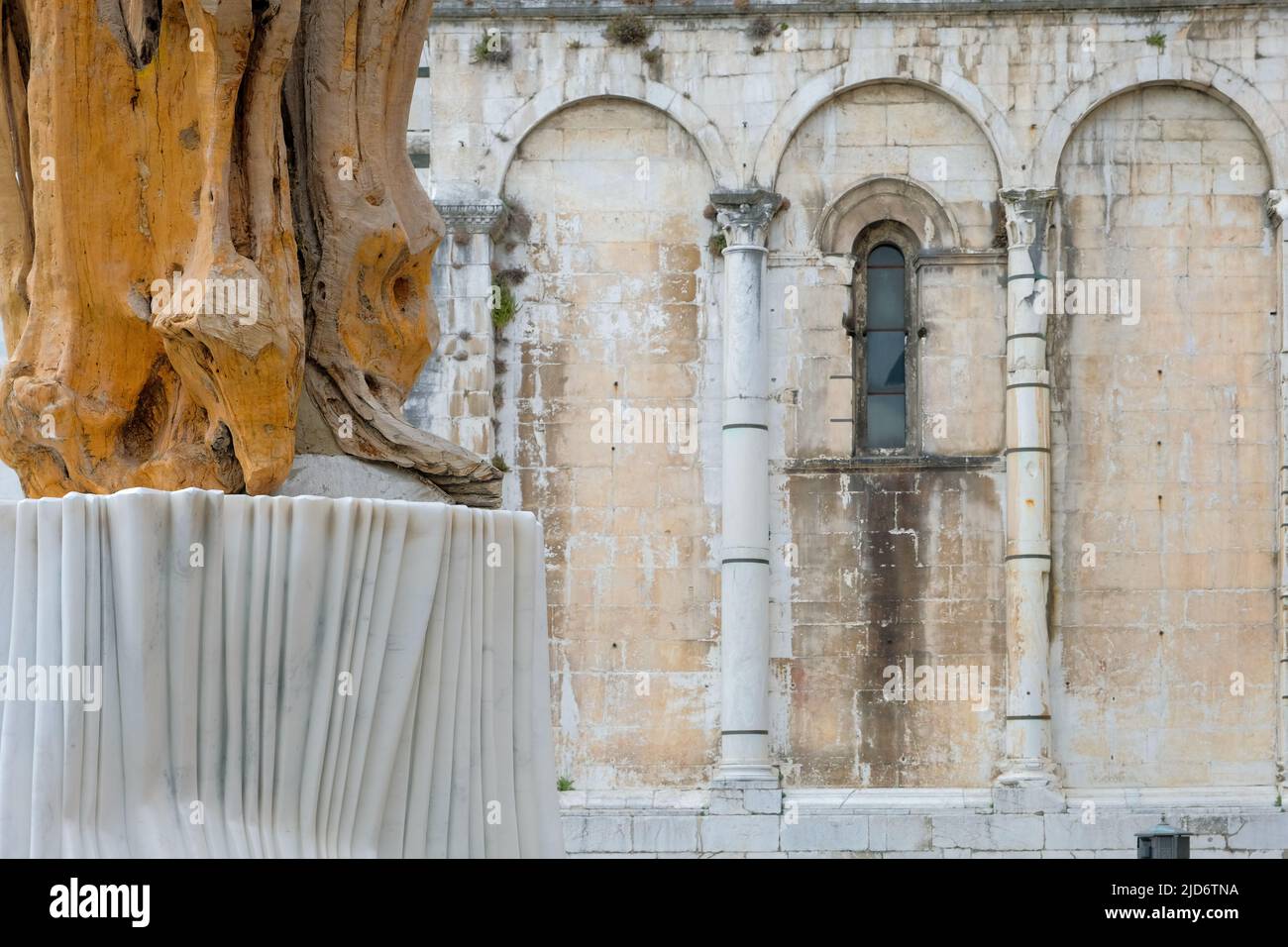 Lucca, Italy, - June 8, 2022: Architectural detail and nearby art piece at the Lucca cathedral in Tuscany, Italy. Stock Photo