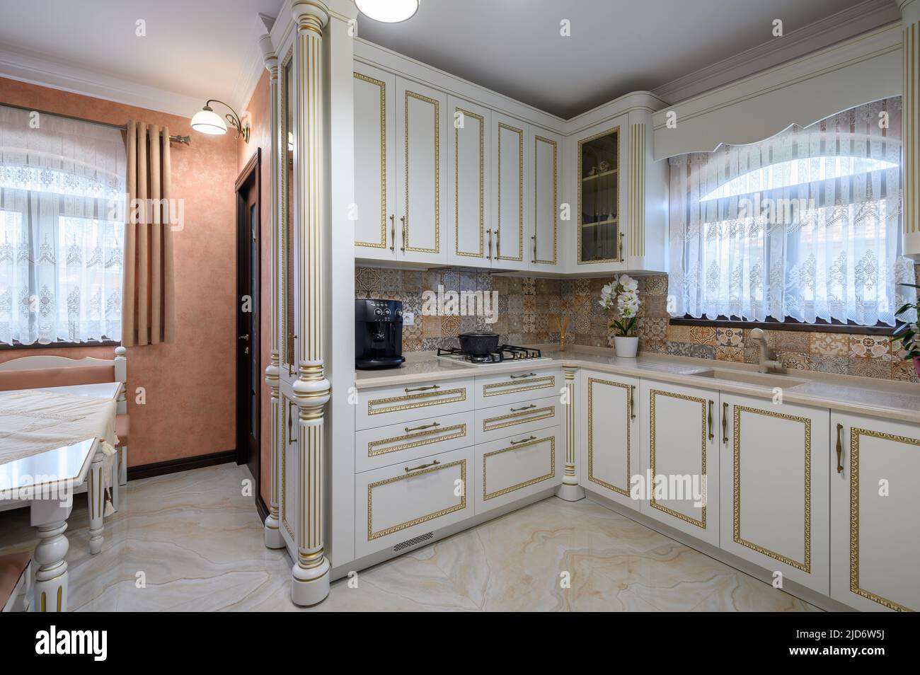 White classic cozy kitchen and dining room in city house Stock Photo