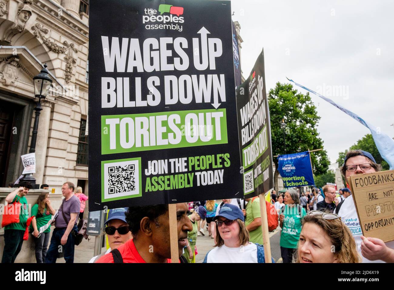 London UK, 18th June 2022. Thousands of trade union members march on the We Demand Better protest organised by the TUC against the UK government. Placards call for a rise in workers' wages and reduction in household bills. Stock Photo
