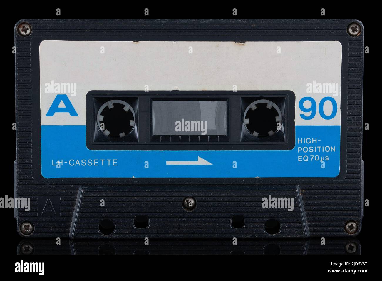 Retro vintage compact cassette and its mirror reflection on black background. Stock Photo