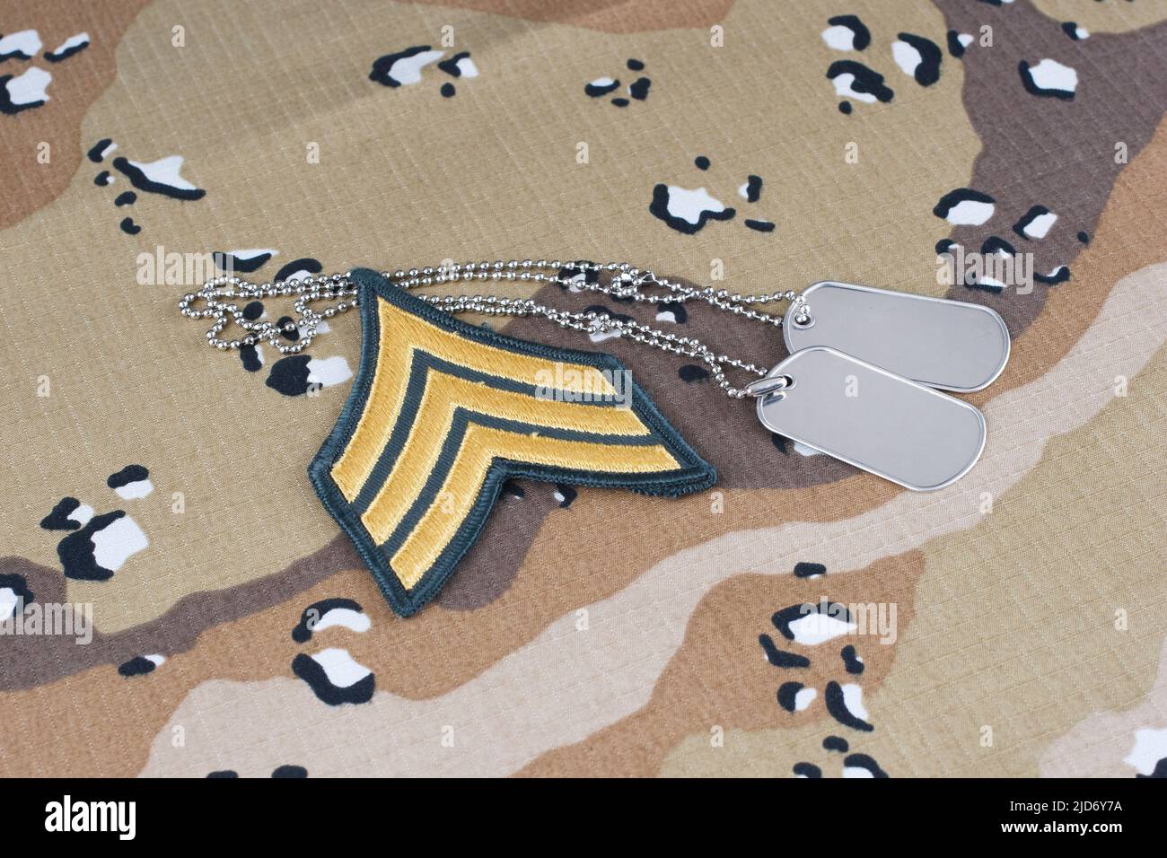 May 12, 2018. US ARMY Sergeant rank patch and dog tags on Desert Battle Dress Uniform Stock Photo