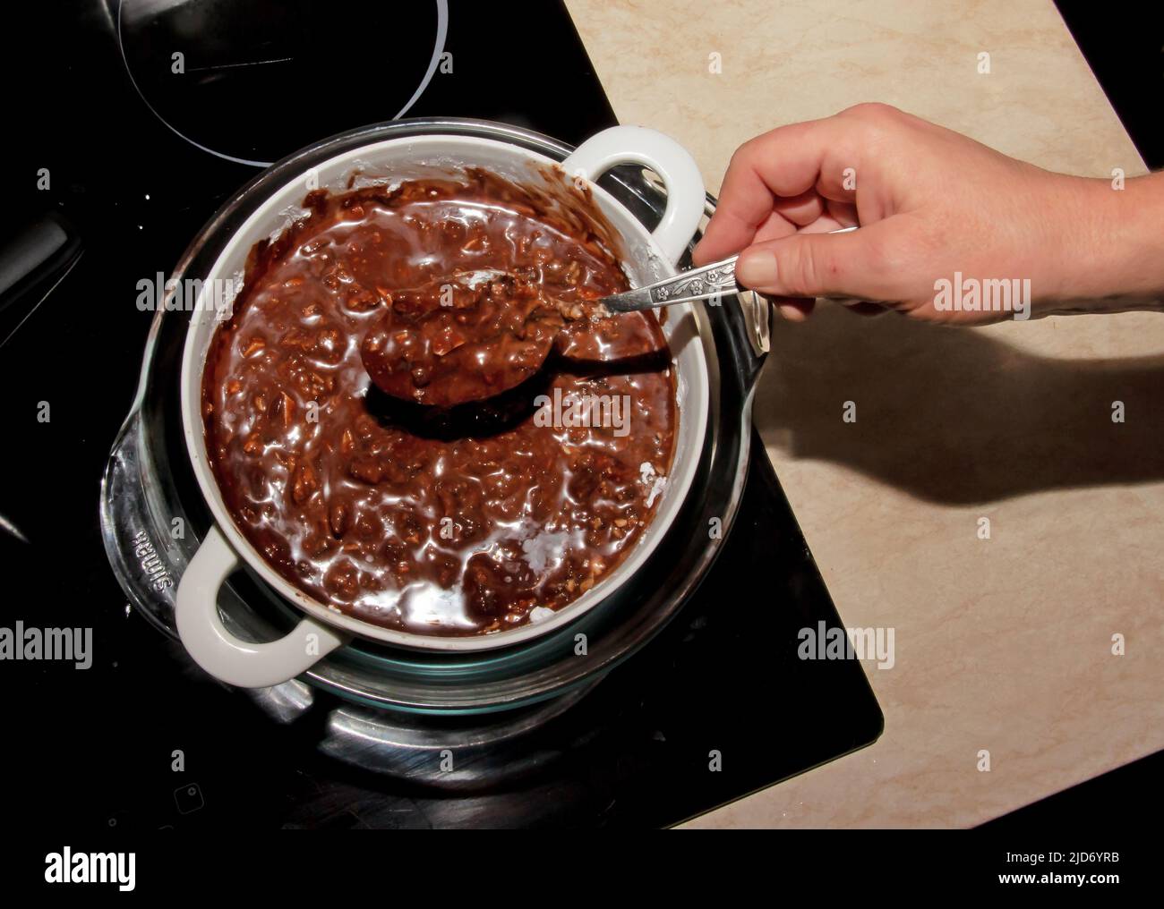 Powdered sugar, cocoa butter and grated cocoa in a container for making