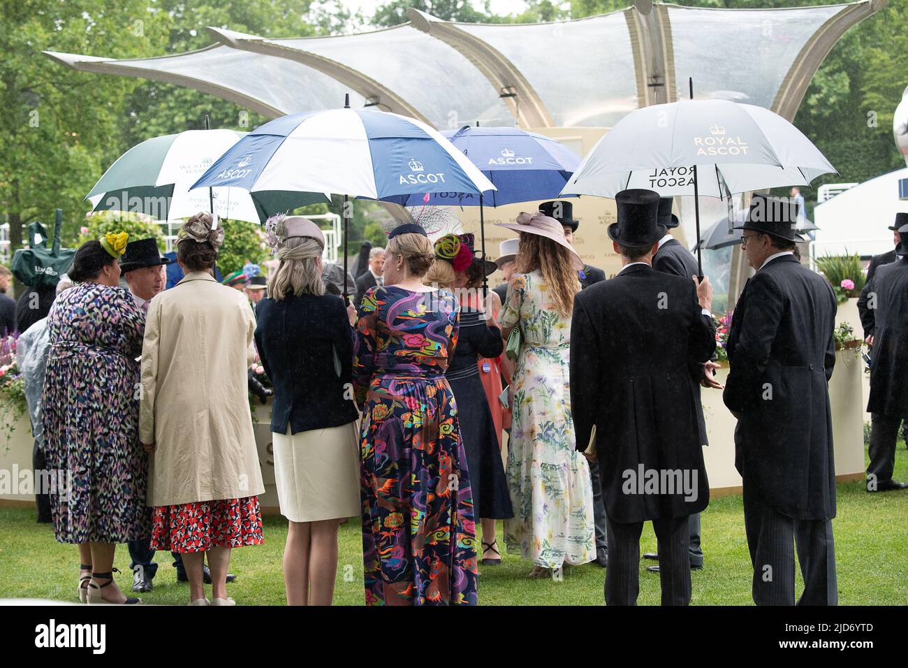 Ascot, Berkshire, UK. 18th June, 2022. The umbrellas were out again this afternoon at Royal Ascot after a few intermittent showers. Credit: Maureen McLean/Alamy Live News Stock Photo