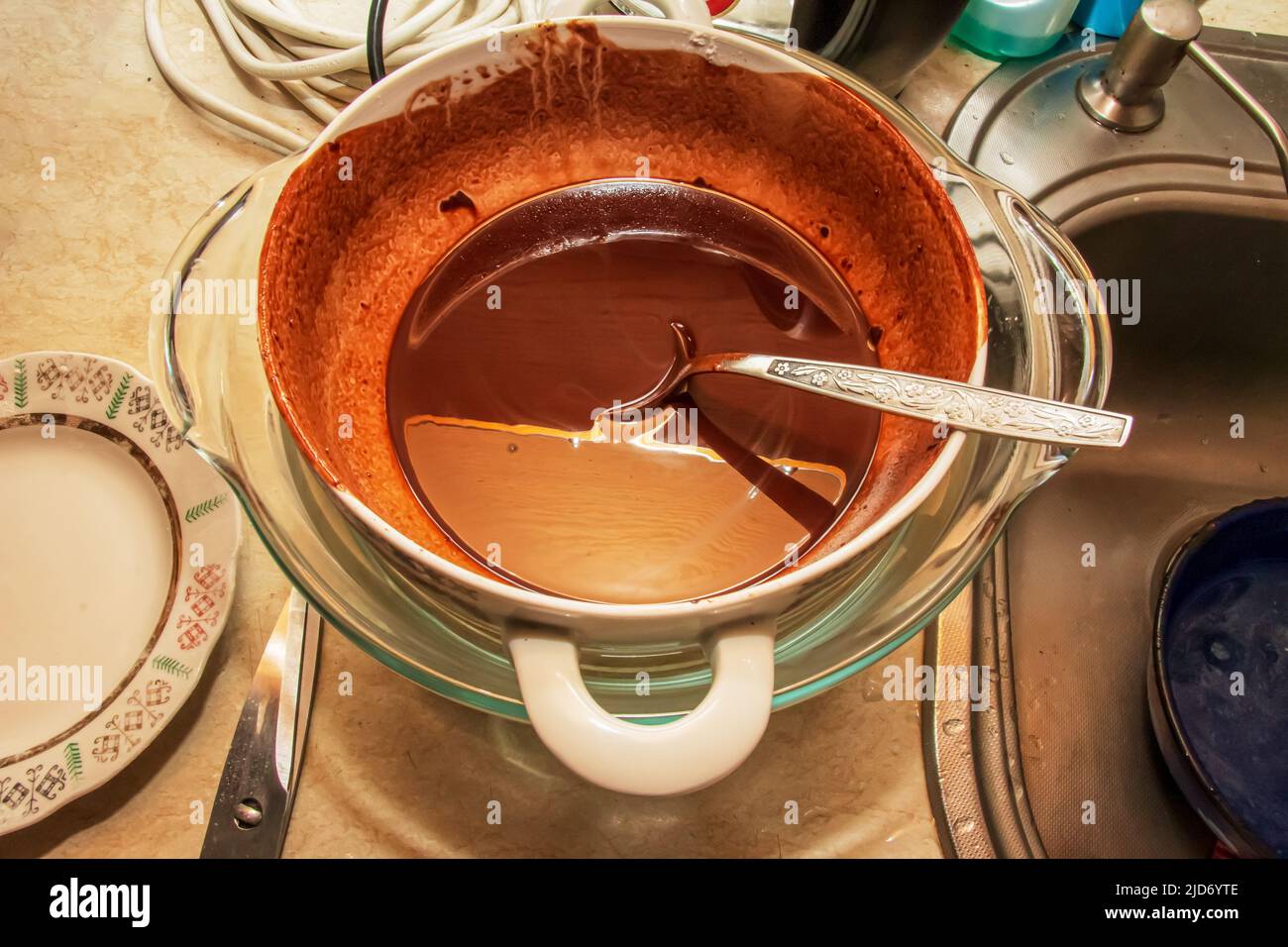 Homemade hot chocolate is ready to be poured into silicone molds. Stock Photo