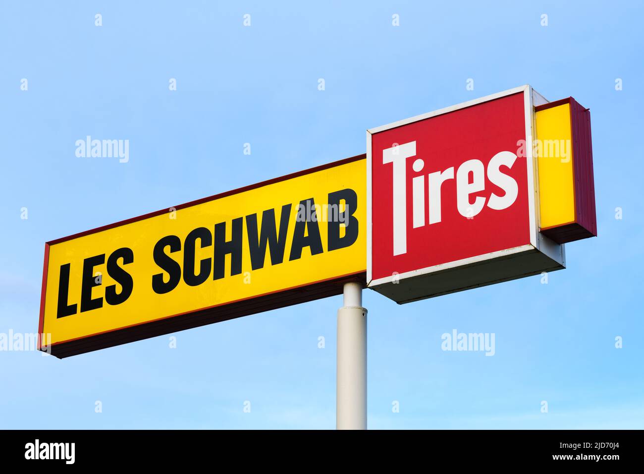 North Bend, WA, USA - June 16, 2022; Signage for Les Schwab Tires isolated against a blue sky Stock Photo