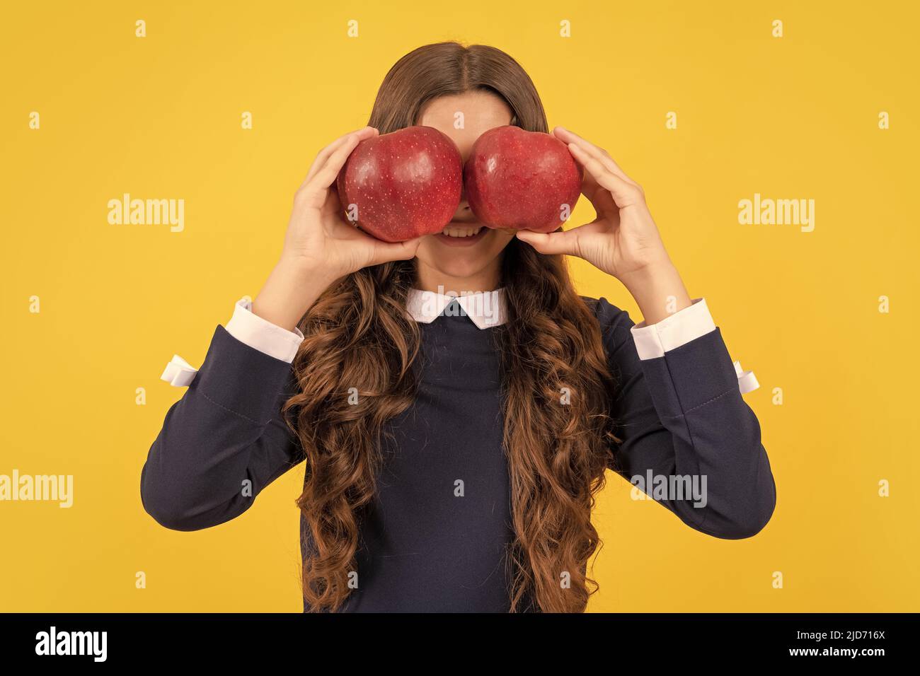 funny teen girl hold red vitamin apple for lunch on yellow background, lunch  time Stock Photo - Alamy