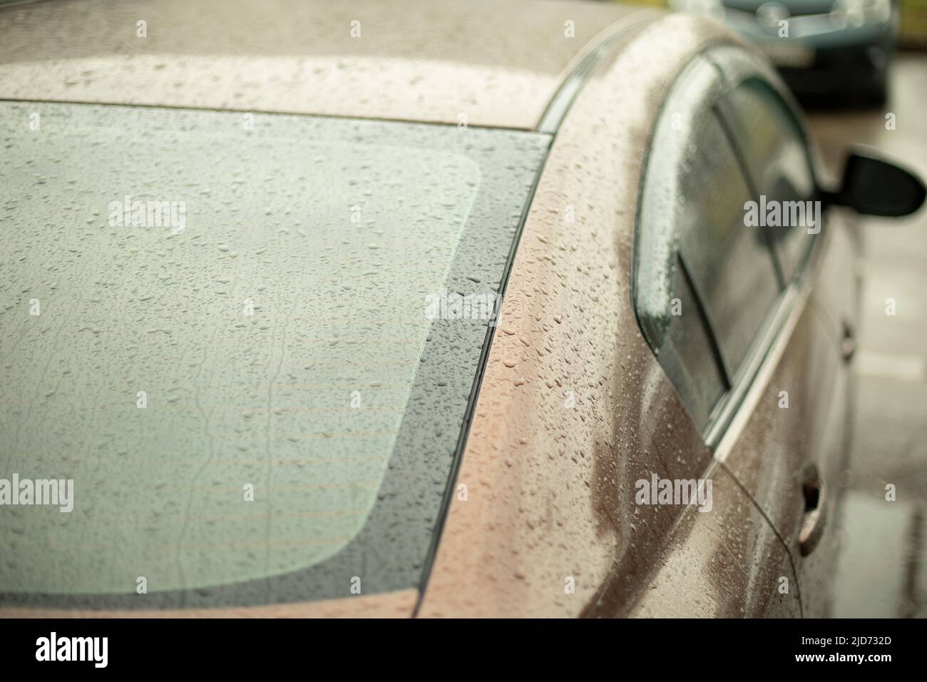 Wet car. Drops on transport. Car in rain in parking lot. Small droplets
