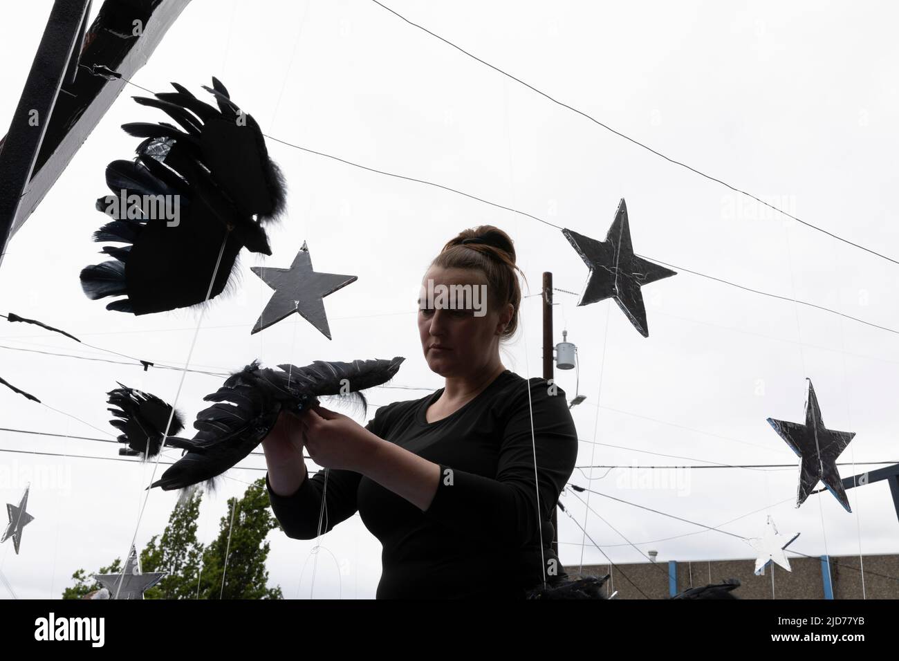 Seattle, Washington, USA. 18th June, 2022. Local sculptor Katie Kurkjy works on a Beatles inspired piece “Blackbird” for the Fremont Solstice Parade. The iconic, annual parade returned after a three-year hiatus due to the coronavirus pandemic. Credit: Paul Christian Gordon/Alamy Live News Stock Photo