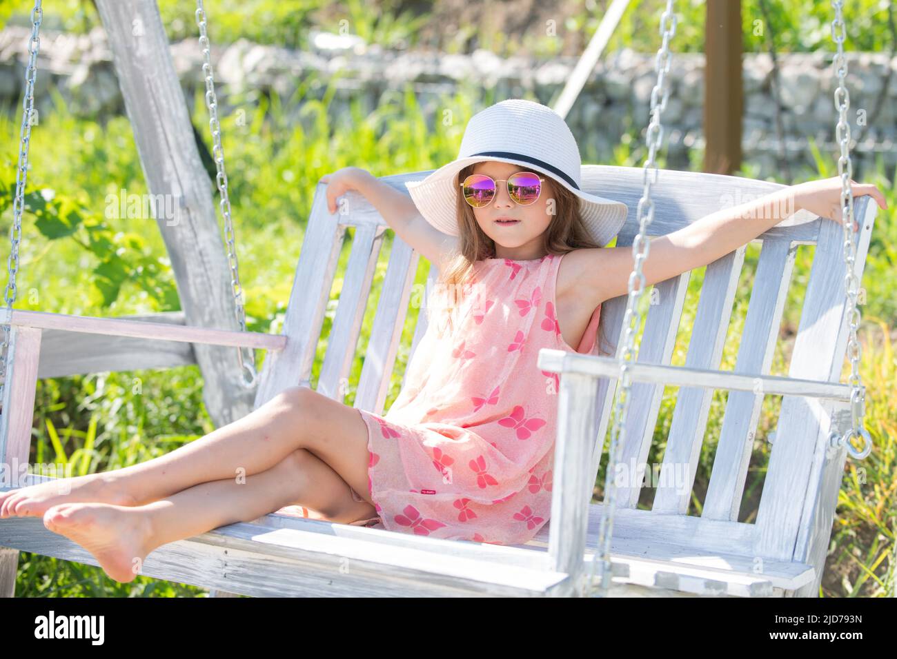Child playing on swing. Healthy summer activity for children in warm