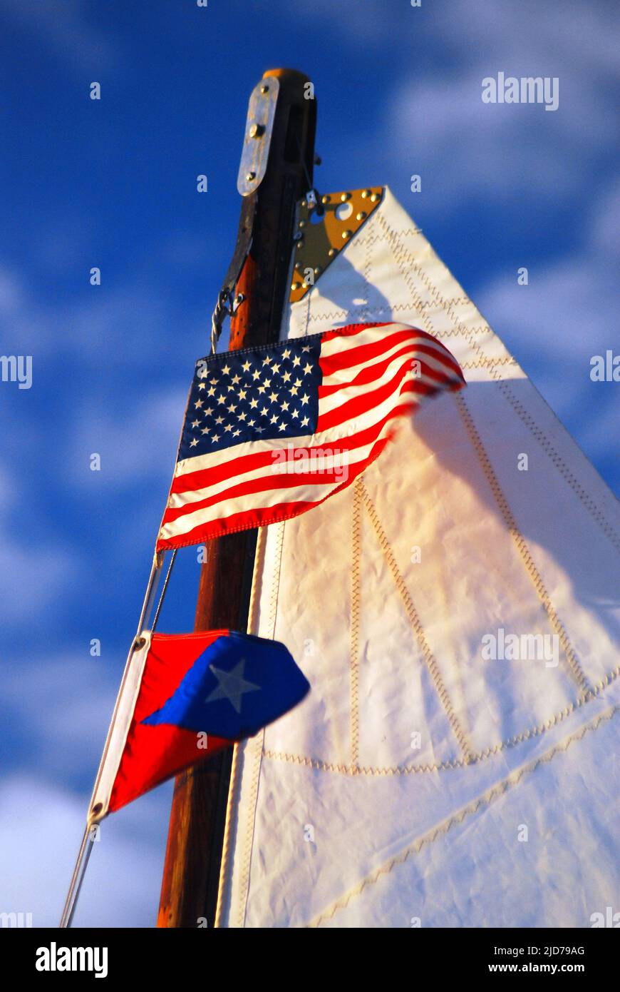 An American flag and the banner of the Red Bank Yacht Club fly at the top of a mast on an Ice yacht Stock Photo