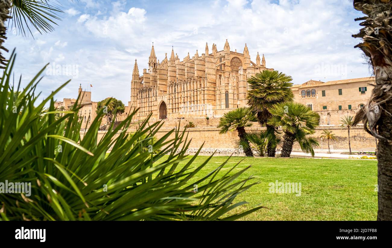 Side view of the majestic gothic style Cathedral of St. Mary of Palma de Mallorca known as La Seu de Mallorca outside illuminated by sunlight at day. Stock Photo