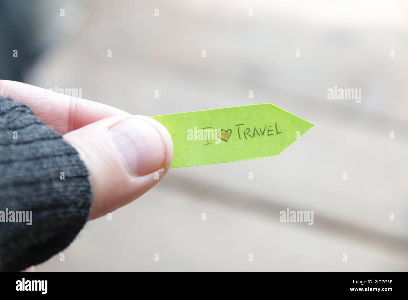 I love to travel concept. A man holds a pointer with an inscription. Stock Photo