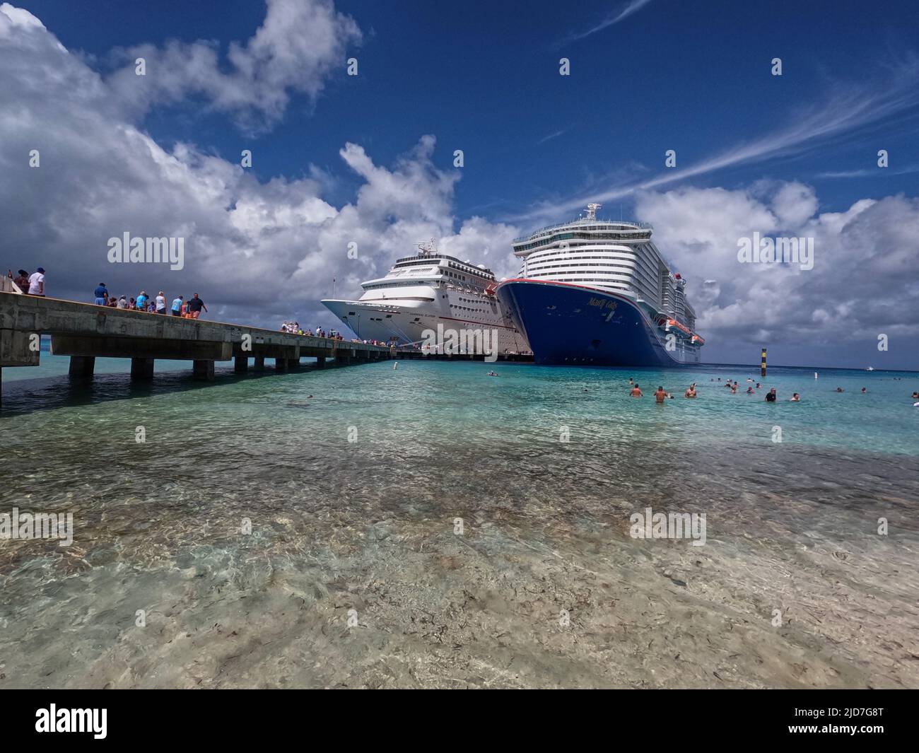 Numerous tourist leaving two cruise liners in the morning (Grand Turk, Turks and Caicos). Stock Photo