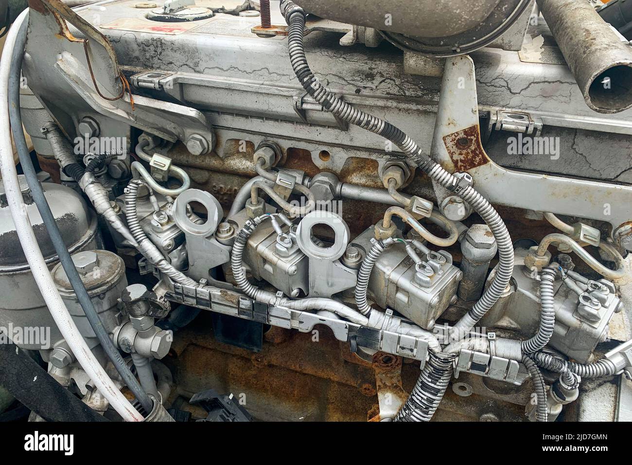 Closeup of salvage yard of broken cars parts, dirty engine of crashed