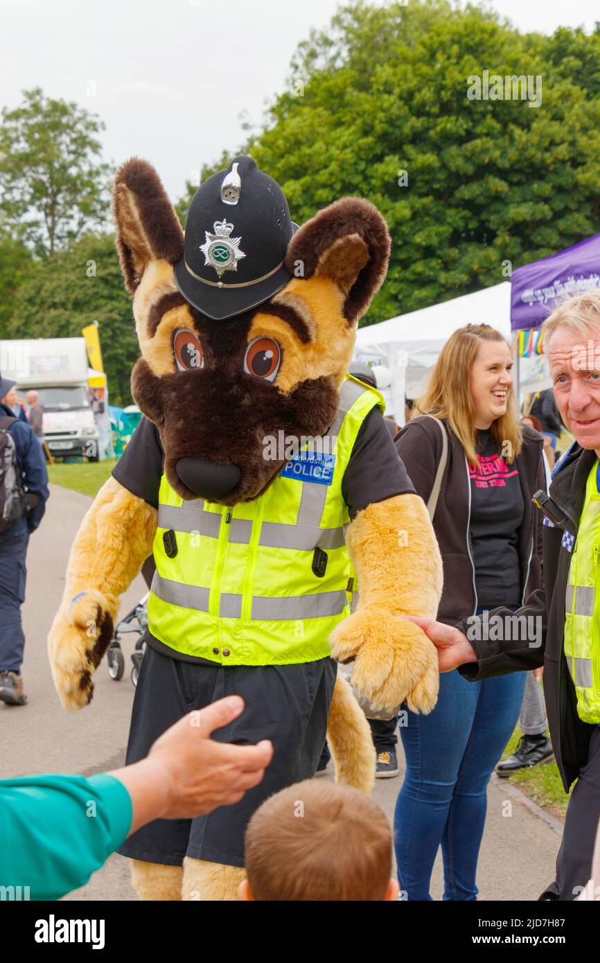 furry bear costume and police officers helmet Stoke Gay Pride event in Hanley Park Saturday 18th June 2022 Stock Photo