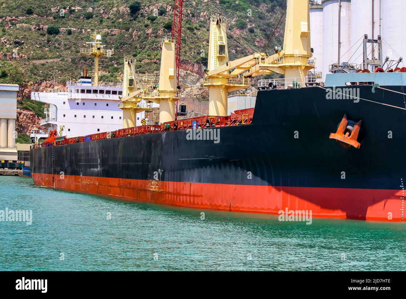 Large cargo ship in the port of the city of Barcelona, loading goods