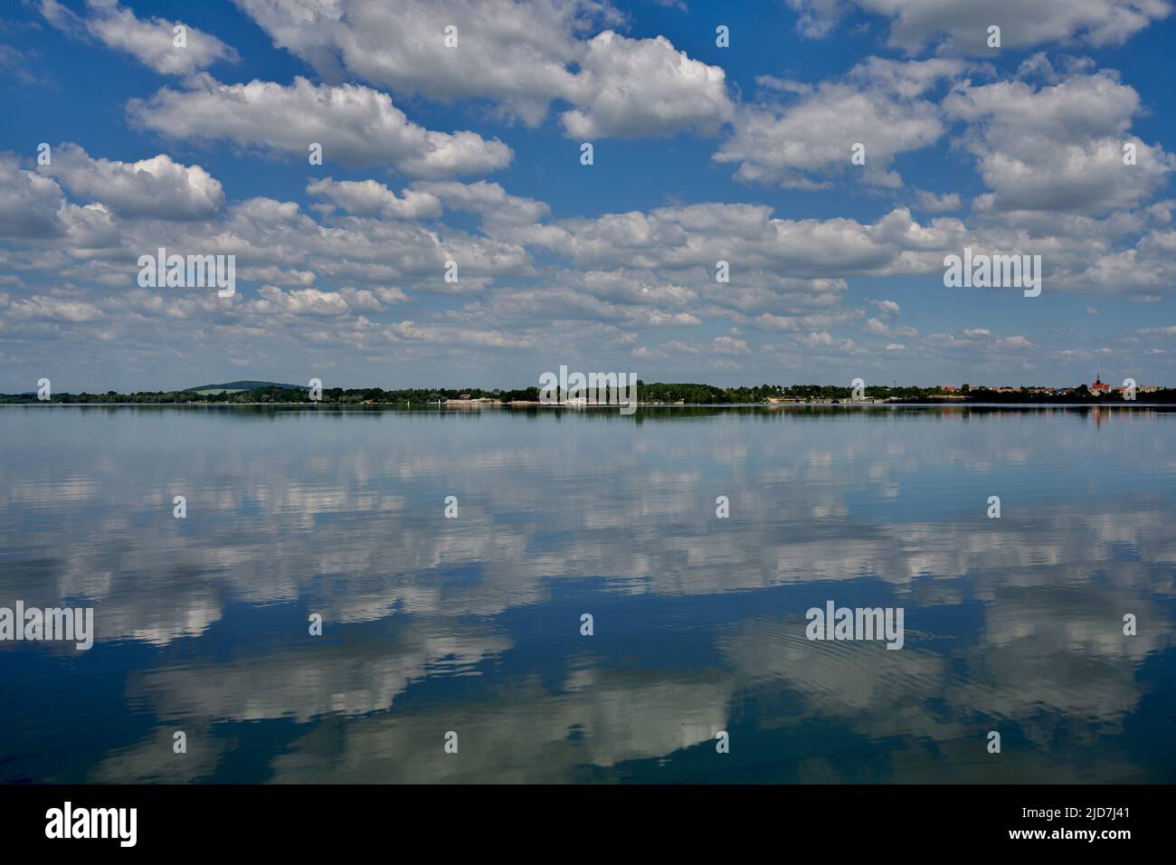 Blue sky with white clouds reflecting on the water Stock Photo - Alamy