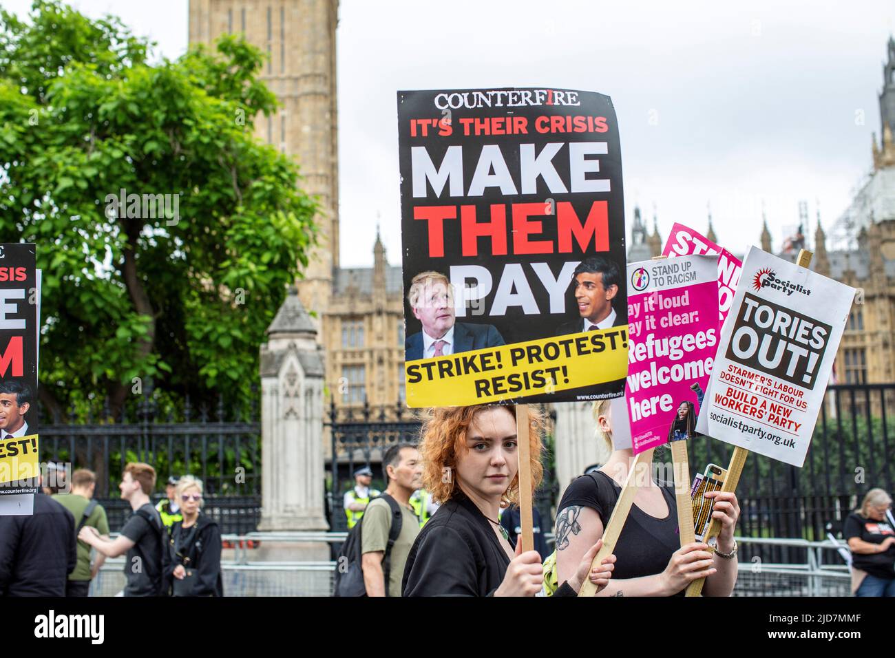 Female protester holds an anti-Tory Government placard during the TUC national demonstration in central London to demand action on the cost of living, Stock Photo