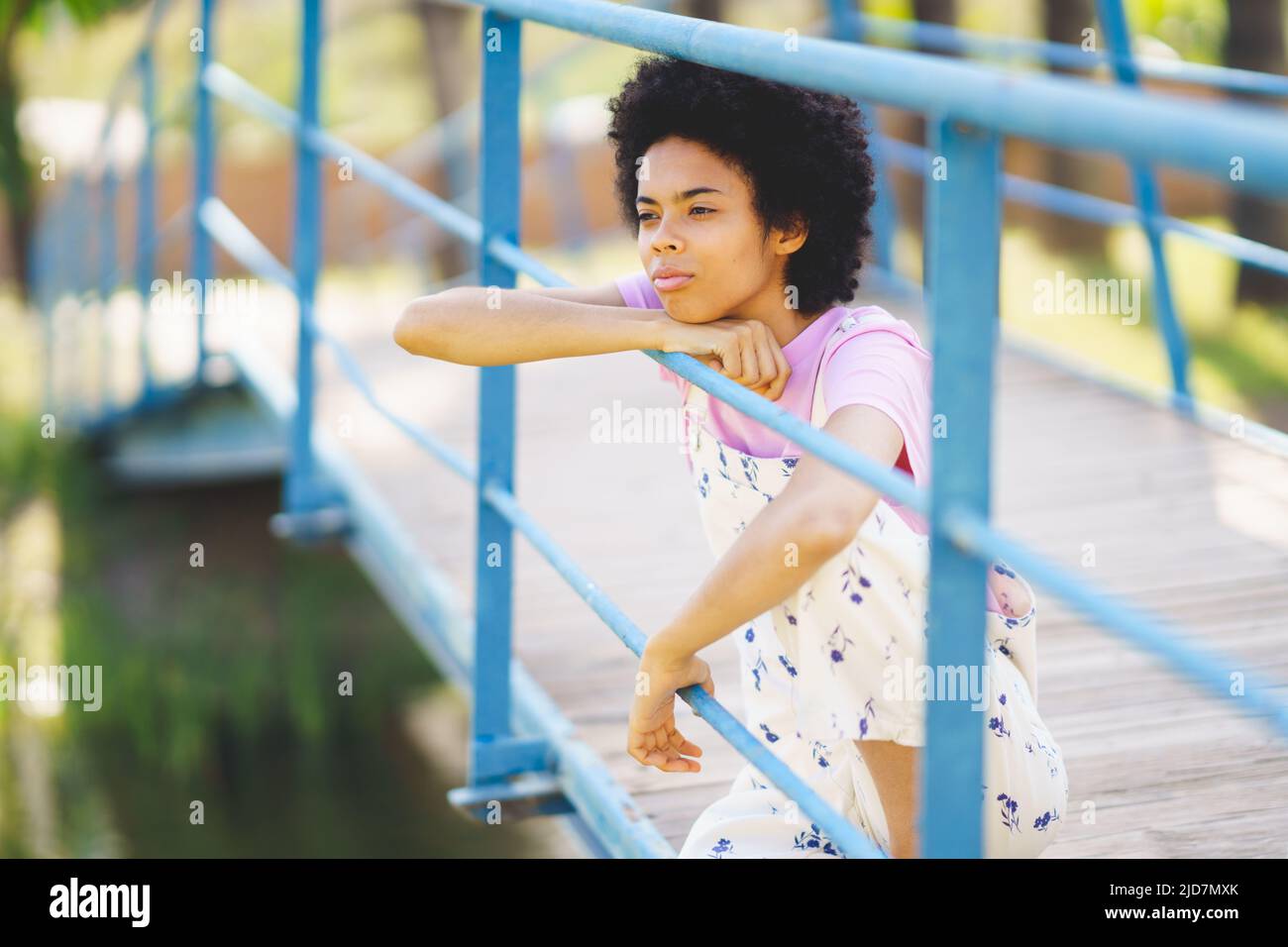 African American girl lost in thought, feeling lonely and depressed, Stock Photo