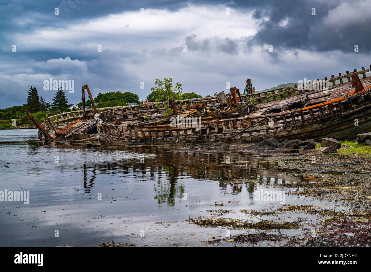 Salen, Isle of Mull, Scotland - Derelict wooden fishing boats abandoned on the beach which is slowly decaying and rotting Stock Photo