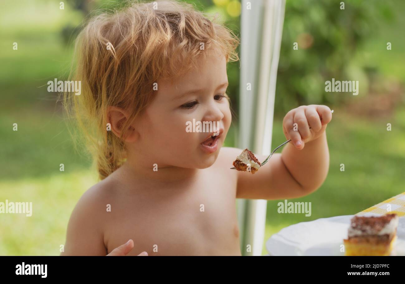 Baby eating cake. Little boy eating cake during cake smash party Stock