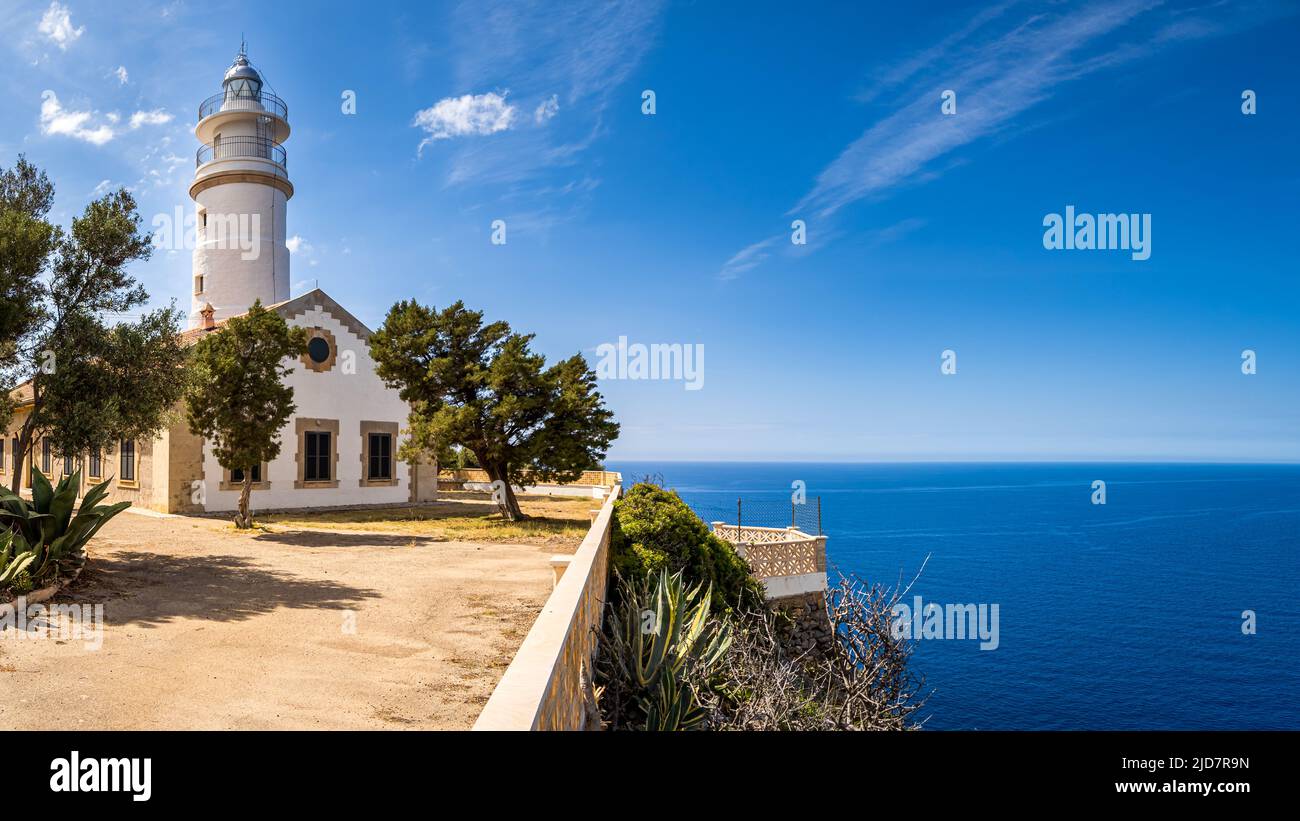 Outside view over the forecourt of a Mallorca lighthouse named Far del Cap Gros in the village Port de Soller with pine trees in the foreground. Stock Photo