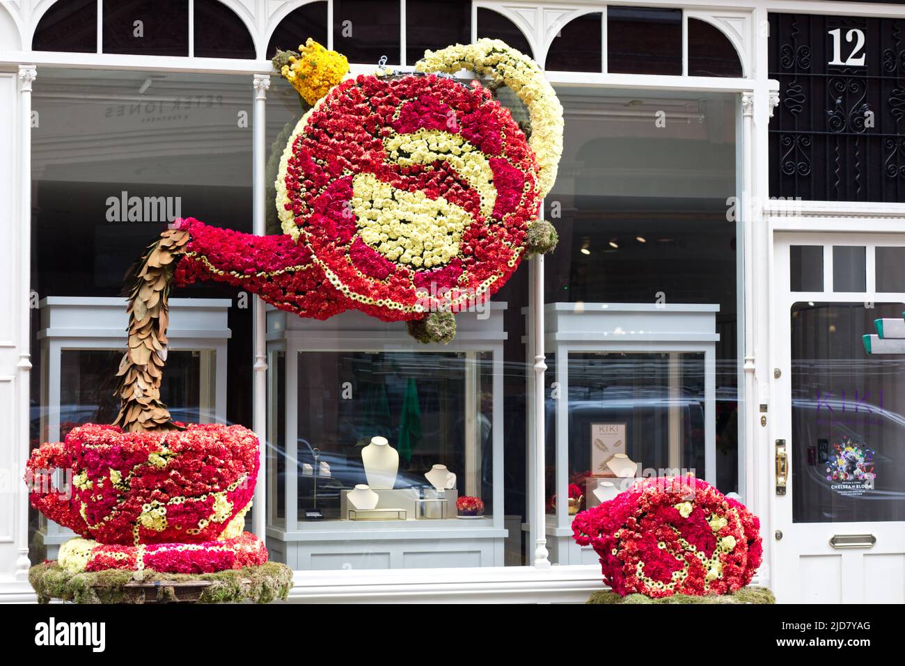 teapot pouring a cup of tea made from flowers Stock Photo Alamy