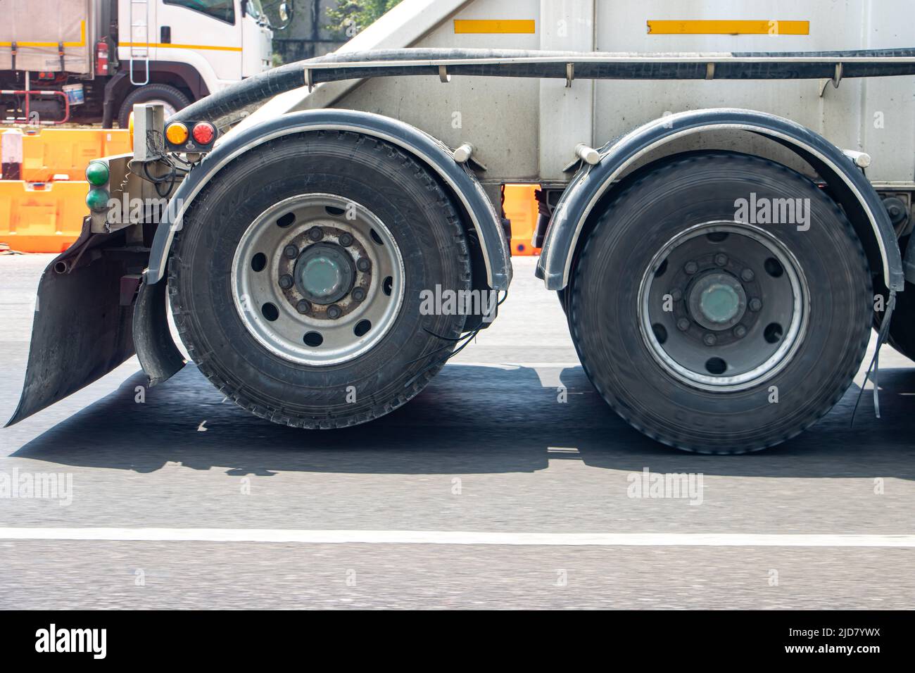 View of the rear wheels of a truck while driving with the rear axle raised Stock Photo