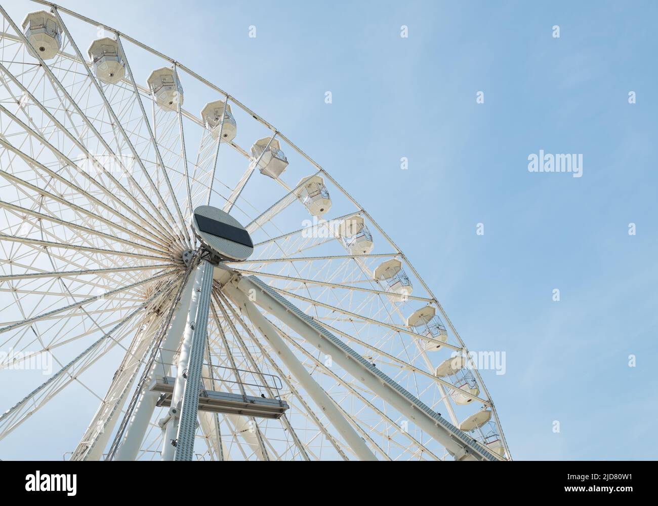 Fairground ferris wheel against a clear blue sky Stock Photo